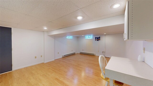8410 Windsor Beach Ct, Erie, PA 16511 - basement featuring a baseboard heating unit, light wood-style flooring, a paneled ceiling, and recessed lighting