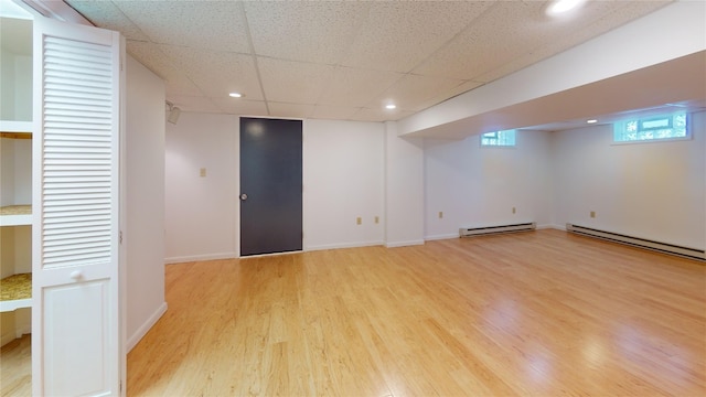 8410 Windsor Beach Ct, Erie, PA 16511 - below grade area with a baseboard radiator, light wood-type flooring, recessed lighting, and a drop ceiling