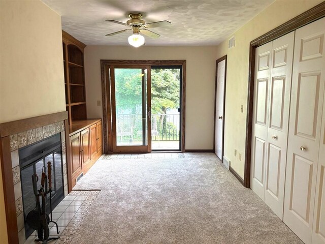 8410 Windsor Beach Ct, Erie, PA 16511 - unfurnished living room featuring ceiling fan, light colored carpet, and a tiled fireplace