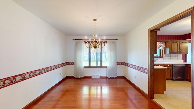 8410 Windsor Beach Ct, Erie, PA 16511 - unfurnished dining area featuring a chandelier and light wood-style flooring