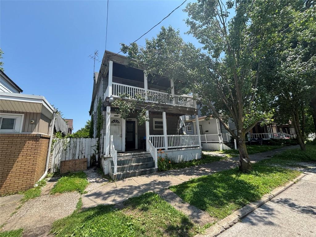 1809 Myrtle St, Erie, PA 16502 - view of front of house featuring covered porch, brick siding, and a balcony