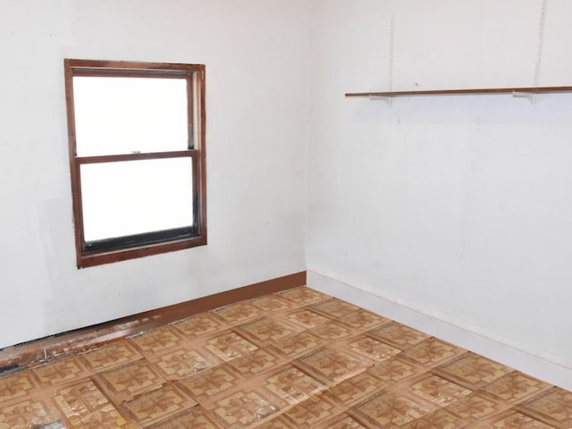 empty room with light floors and baseboards