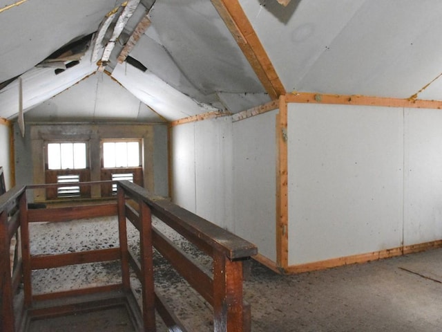 bonus room with baseboards and lofted ceiling