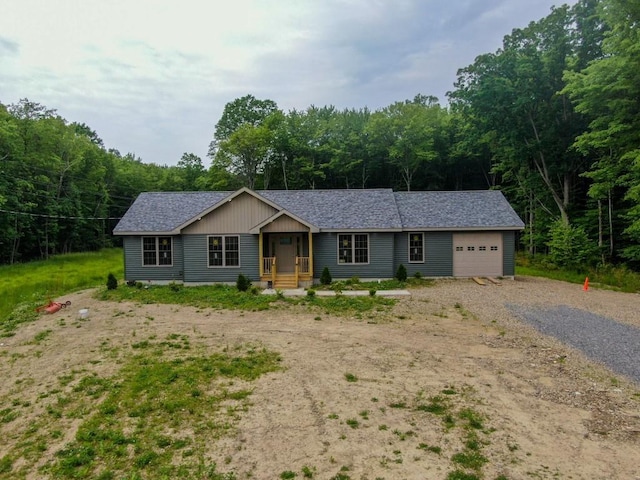 16754 Carr Hill Rd, Meadville, PA 16335 - ranch-style home with gravel driveway, an attached garage, a shingled roof, and a forest view