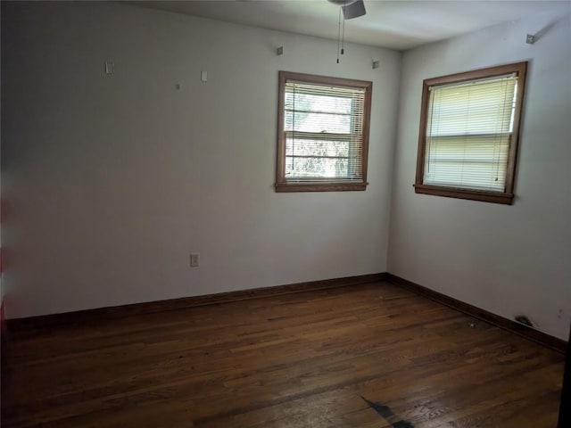 unfurnished room featuring ceiling fan and dark hardwood / wood-style flooring