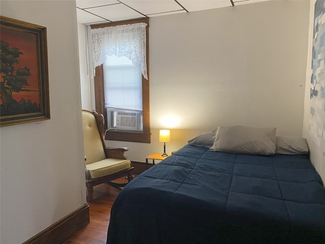 bedroom with hardwood / wood-style floors and cooling unit