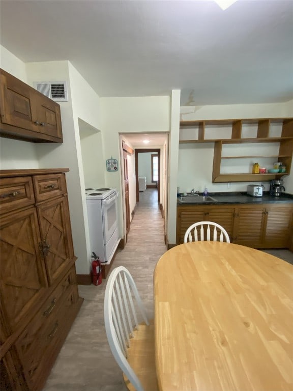 kitchen with white range with electric cooktop and sink