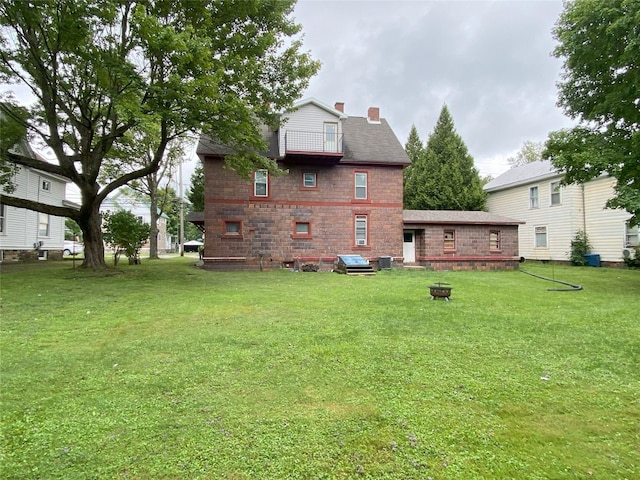 back of property featuring a lawn