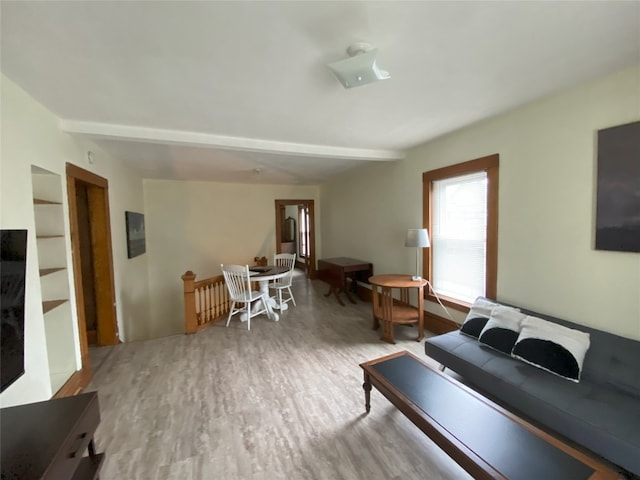 living room with beam ceiling and hardwood / wood-style floors