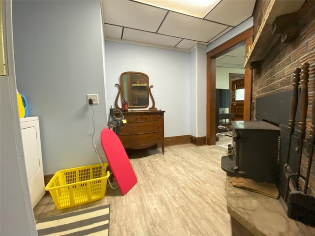 interior space featuring a drop ceiling, wood-type flooring, and washer / dryer