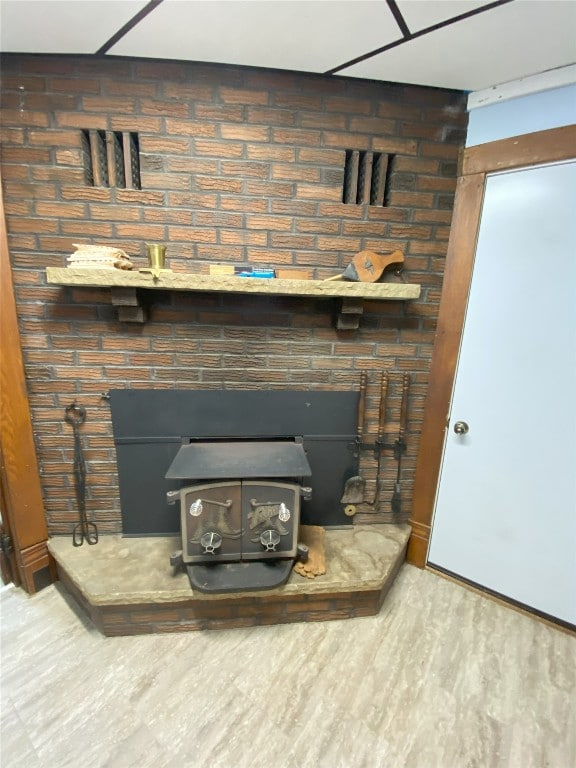 interior details with a wood stove and hardwood / wood-style floors