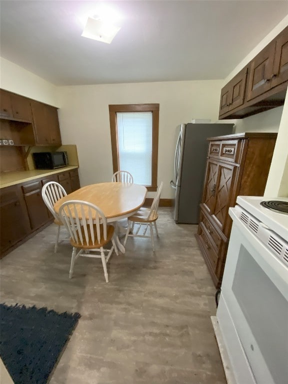 kitchen featuring stainless steel fridge and white electric stove