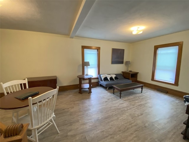 living room with beamed ceiling and hardwood / wood-style flooring