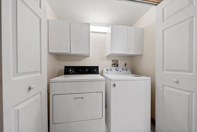 laundry room with washer and dryer and cabinets