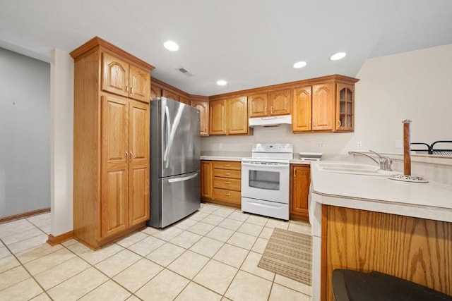 kitchen with light tile patterned floors, white electric range, stainless steel fridge, and sink