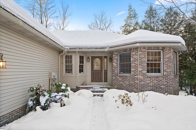 view of snow covered property entrance