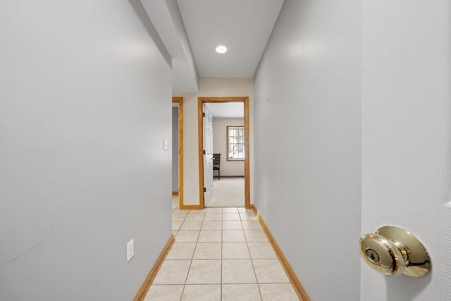 hall with light tile patterned floors