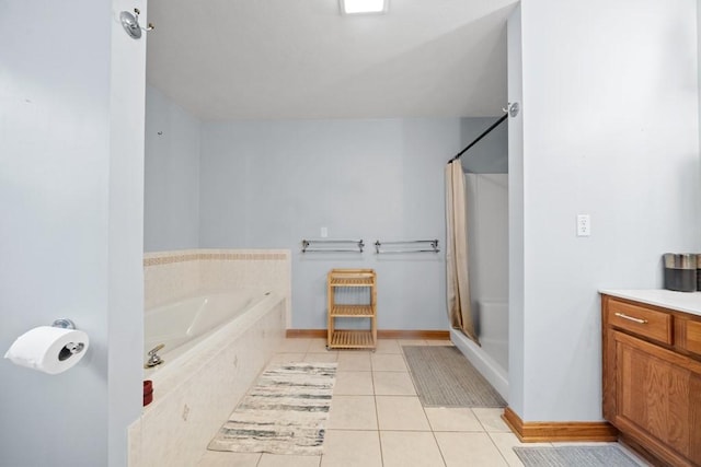 bathroom featuring plus walk in shower, vanity, and tile patterned flooring