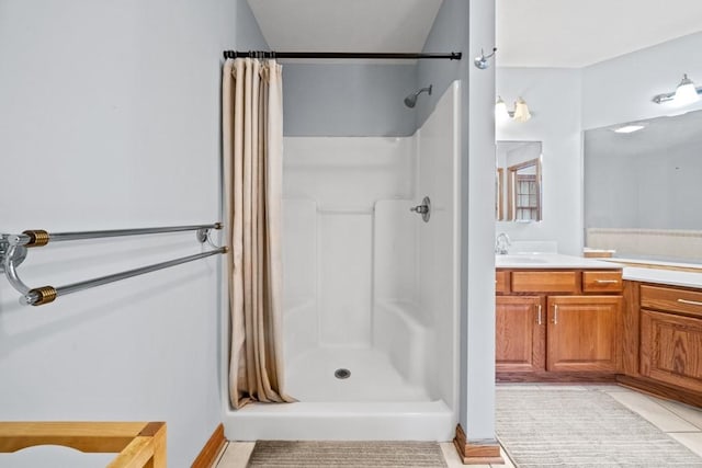 bathroom featuring curtained shower, vanity, and tile patterned flooring