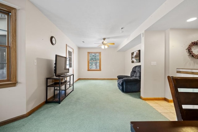 carpeted living room with ceiling fan