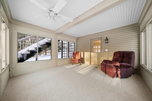 sunroom / solarium with ceiling fan and beamed ceiling