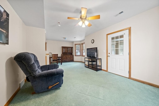 carpeted living room with ceiling fan