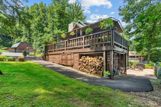 view of side of home featuring a deck and a yard