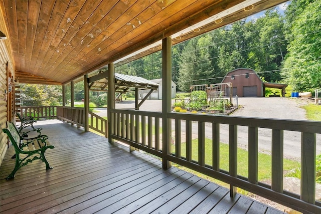 wooden deck with a porch, a garage, and an outdoor structure