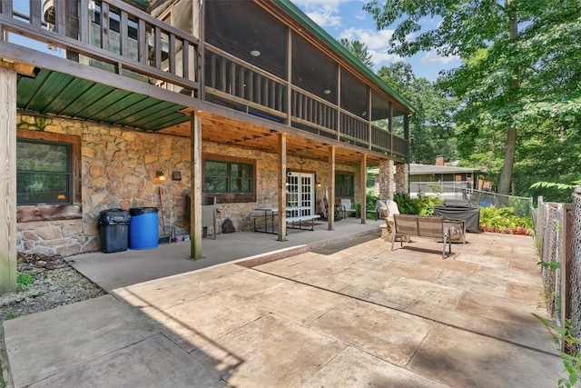 view of patio with a sunroom