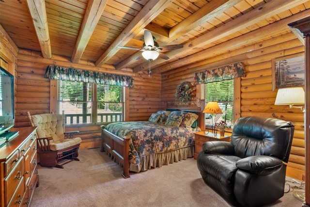 carpeted bedroom featuring beamed ceiling, rustic walls, multiple windows, and ceiling fan