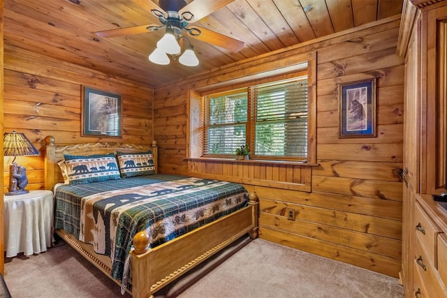 carpeted bedroom featuring ceiling fan, wooden ceiling, and wood walls