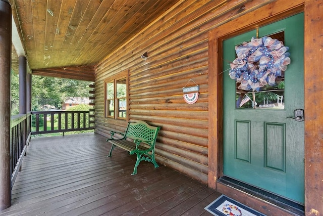 view of exterior entry with a porch