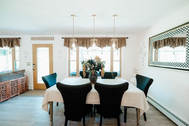 40 Cemetery Rd, Spring Creek, PA 16436 - dining space featuring a baseboard radiator and wood finished floors