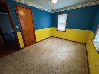 unfurnished room with carpet floors and ceiling fan