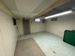 basement featuring a paneled ceiling