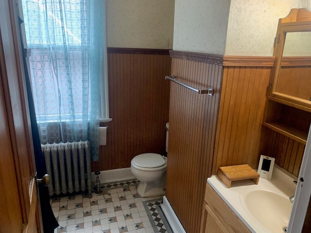 760-762 Park Ave, Meadville, PA 16335 - bathroom with radiator, a wainscoted wall, vanity, wallpapered walls, and wooden walls