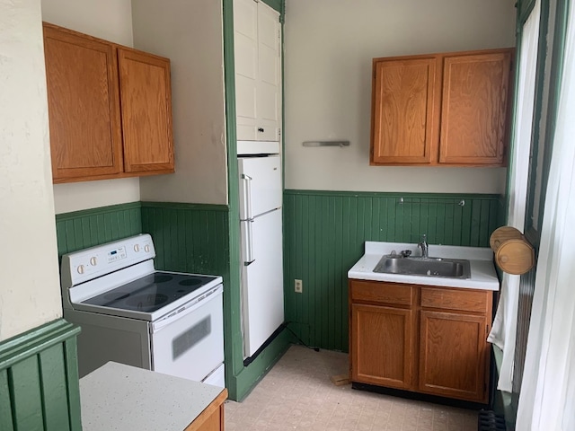 760-762 Park Ave, Meadville, PA 16335 - kitchen featuring white appliances, a wainscoted wall, light countertops, and brown cabinets