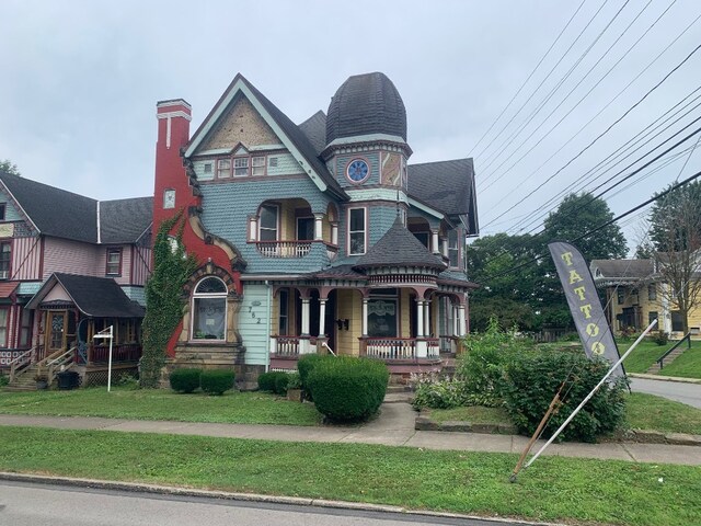 760-762 Park Ave, Meadville, PA 16335 - victorian home featuring covered porch, a chimney, and a front lawn