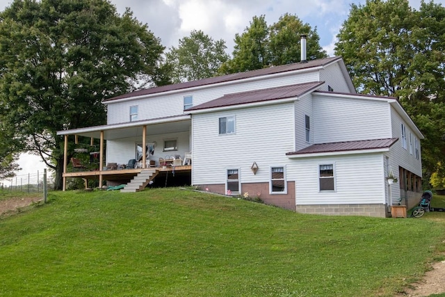 rear view of property with a lawn