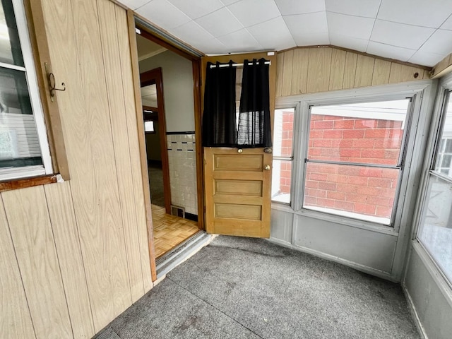 spare room with light parquet flooring, plenty of natural light, and lofted ceiling