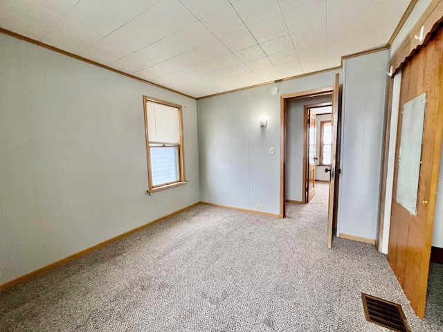 carpeted spare room with ornamental molding