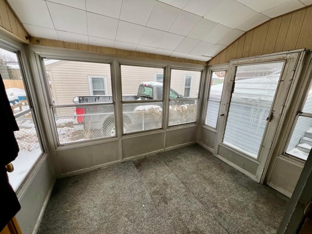 unfurnished sunroom with lofted ceiling and a healthy amount of sunlight