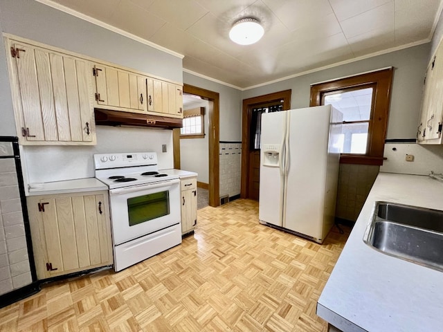 kitchen with a wealth of natural light, sink, light parquet floors, and white appliances