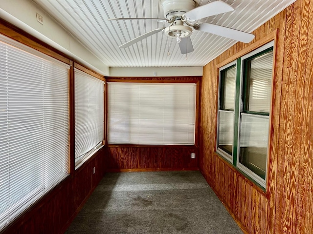 unfurnished sunroom with ceiling fan