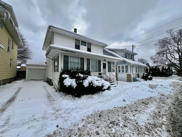 view of property with a garage and an outbuilding