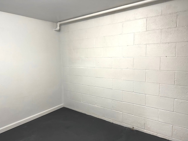 below grade area featuring concrete block wall