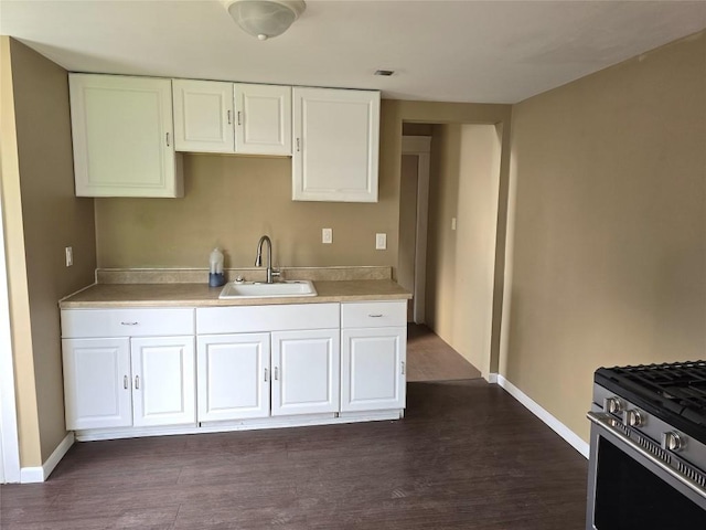 1051-1053 W 9th St, Erie, PA 16502 - kitchen featuring stainless steel range with gas cooktop, dark wood-type flooring, white cabinets, and light countertops