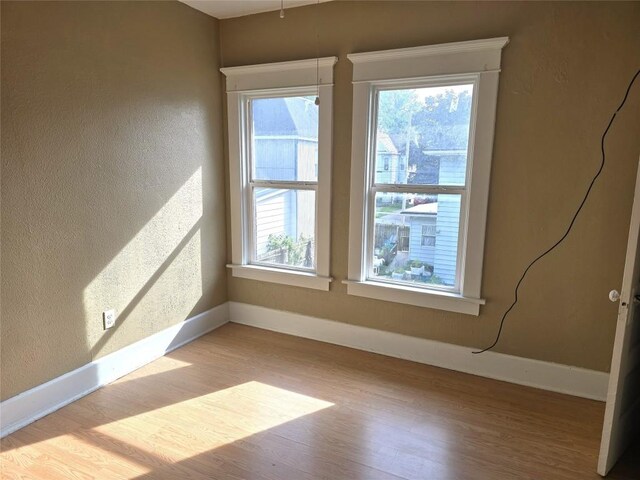 1051-1053 W 9th St, Erie, PA 16502 - spare room with wood finished floors and a textured wall