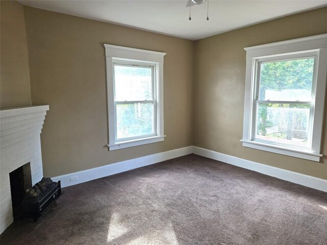 1051-1053 W 9th St, Erie, PA 16502 - unfurnished living room featuring healthy amount of natural light, carpet, and a fireplace