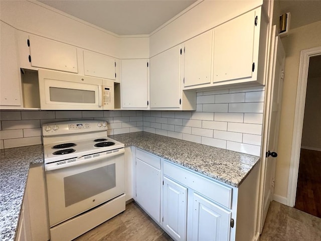 kitchen featuring white appliances, white cabinetry, and decorative backsplash